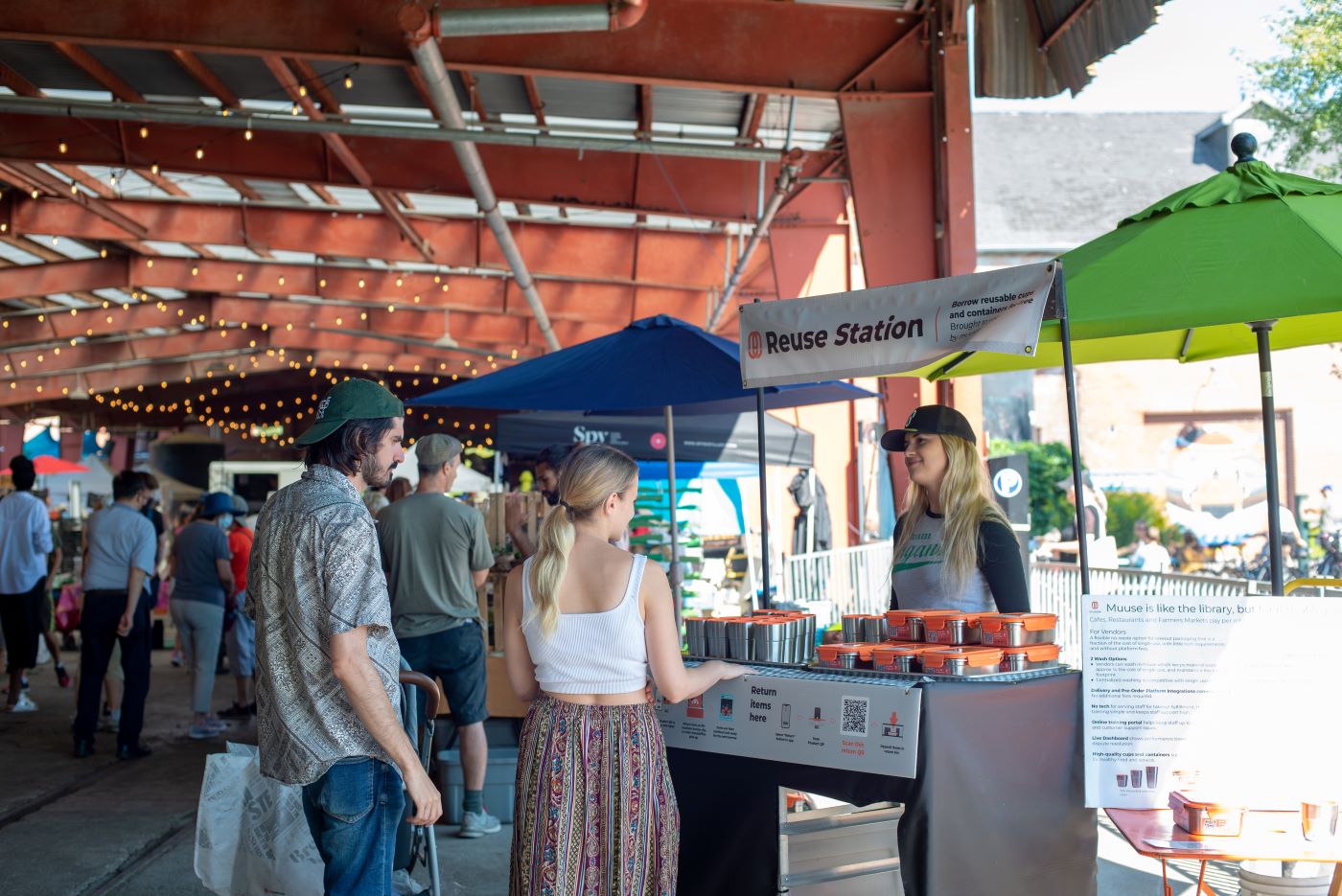 People using a reusable container service at Evergreen Brick Works farmers market