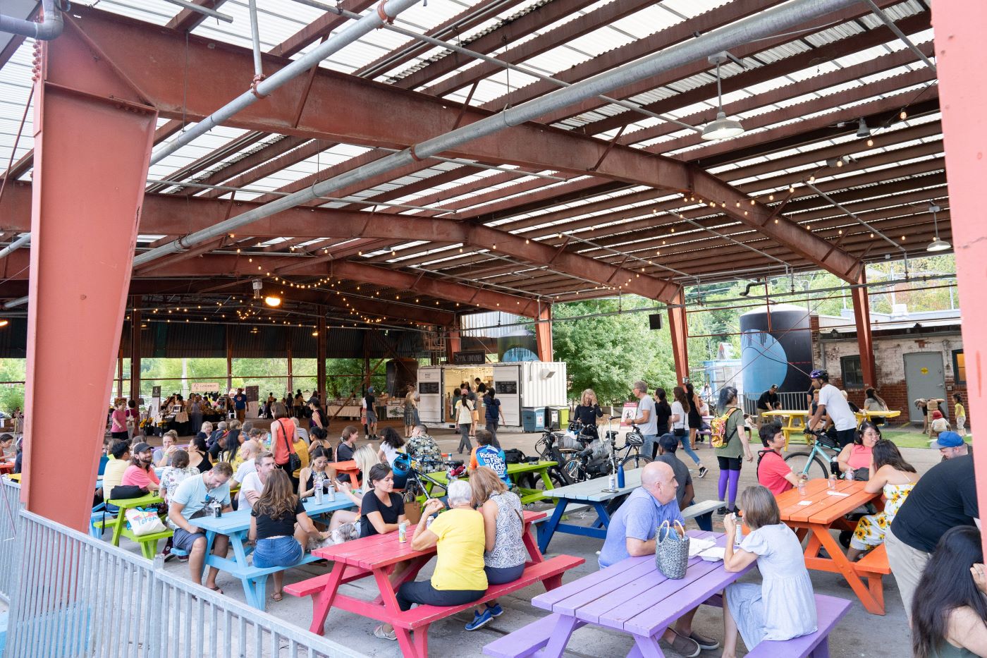 Groups of people sat at picnic benches at Evergreen Brick Works