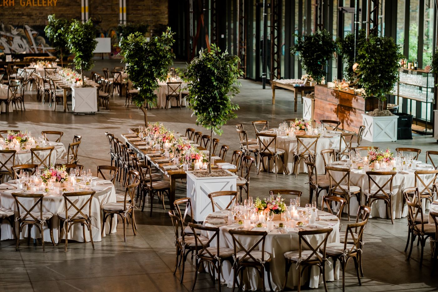 Evergreen Brickworks CRH aerial view of event space wedding setup with decorated tables and trees throughout.
