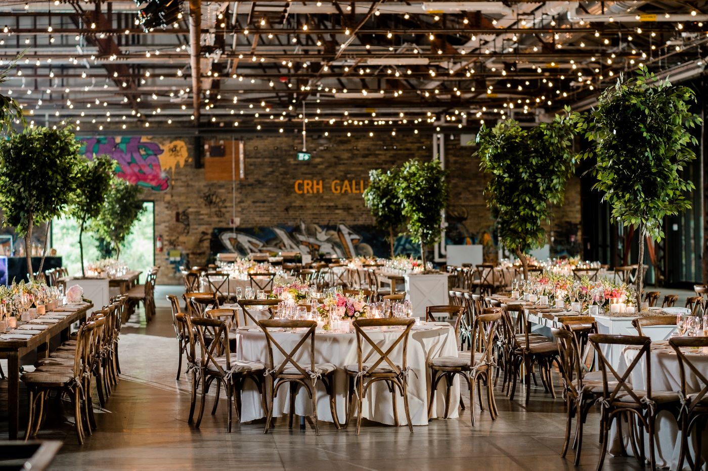Evergreen Brickworks CRH event space wedding setup with twinkle lights, candles, trees and decorated tables