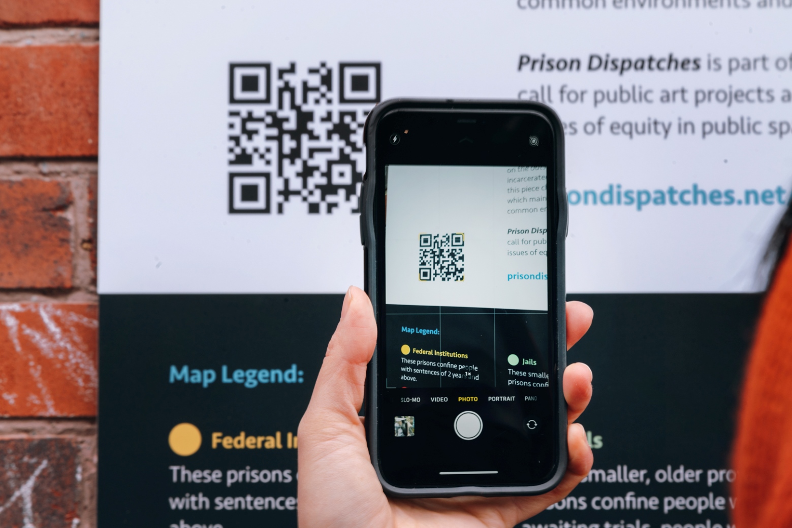 Woman holding cell phone showing a QR code scan.