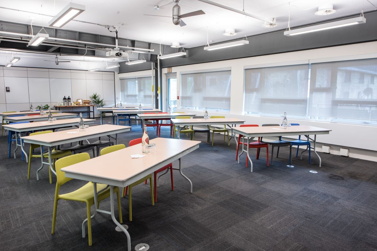 Blakes meeting room with 10 tables setup herringbone style.