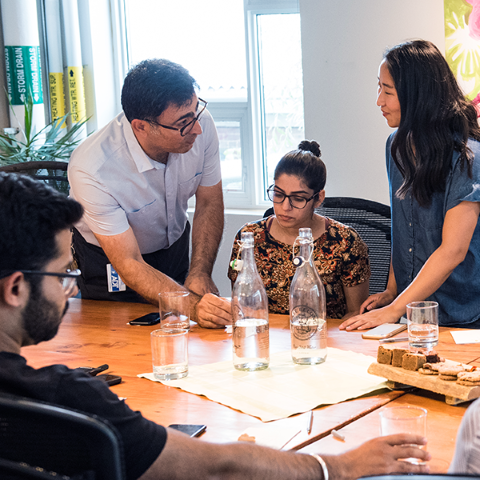 People gathered around a conference table deep in discussion