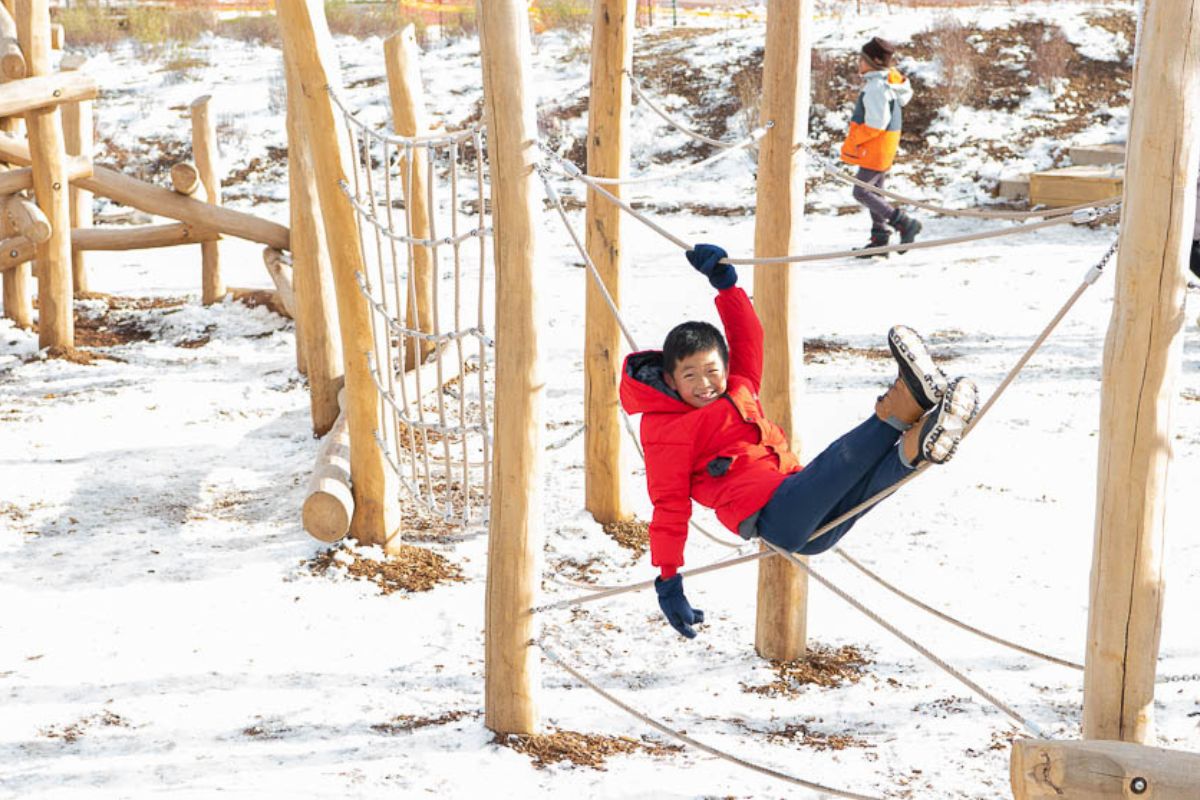 Kid playing at a climate ready school.