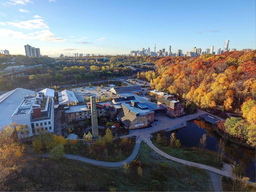 Drone view of Evergreen Brick Works with Toronto city scape
