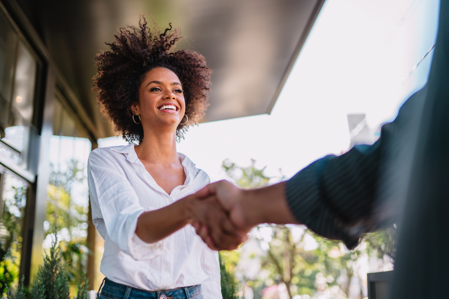 Business partners shake hands like hello in office closeup.