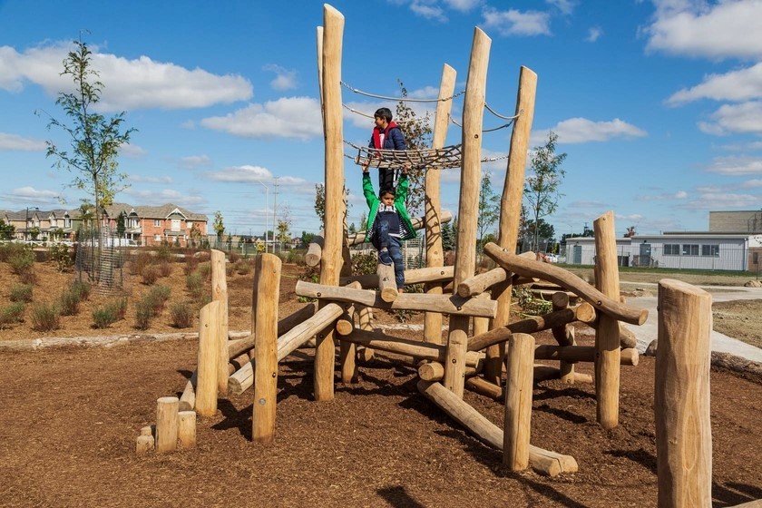 Two kids enjoying the Irma Coulson School Parkour Birds Nest.