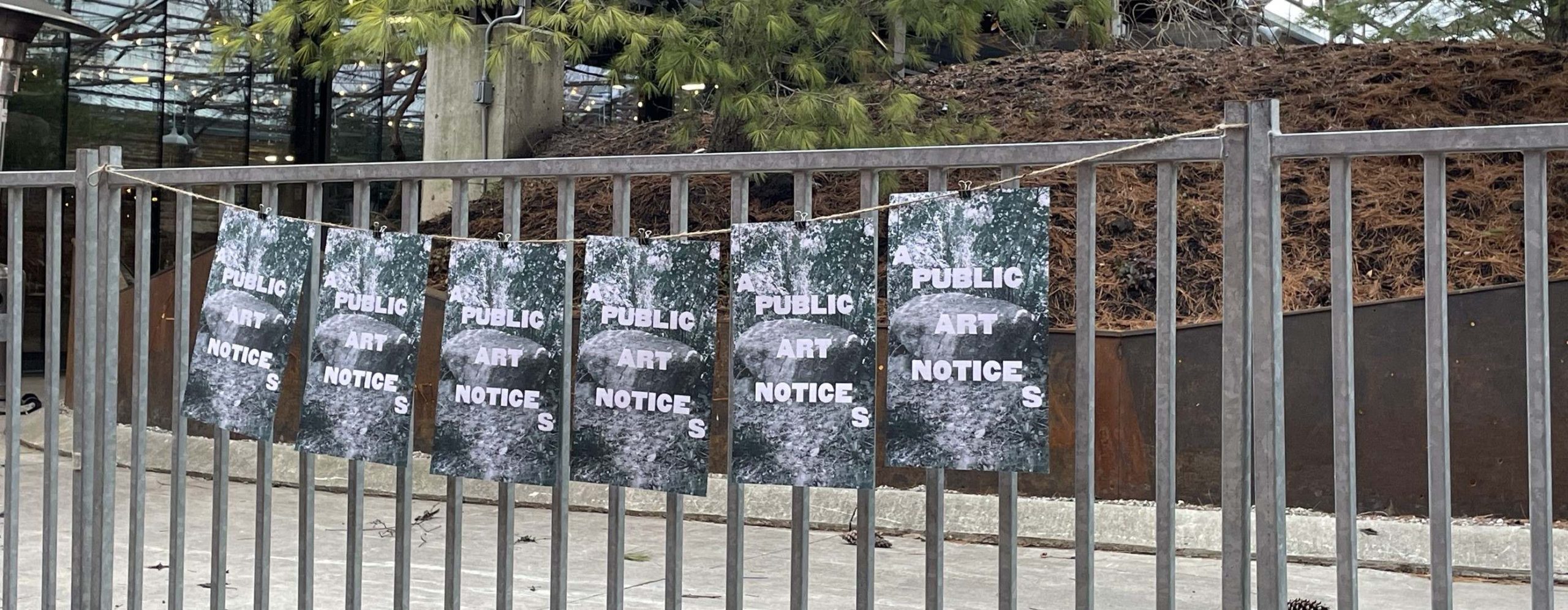 posters strung up along railing that say 