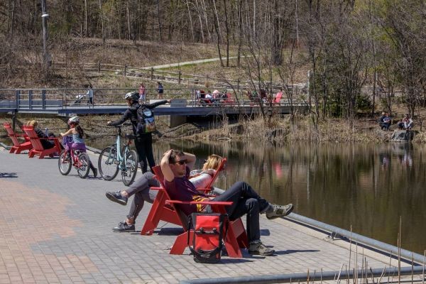 people sitting on Muskoka chairs at the Brick Works