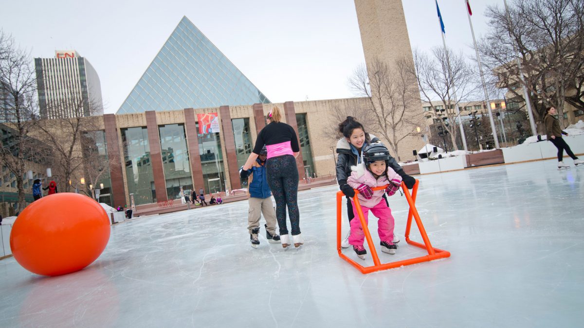 Family skating outdoors on public ice rink