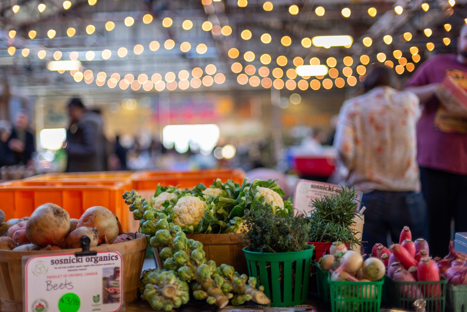 Assortment of local produce including brussels sprouts, beets and cauliflower at the indoor Saturday Farmers Market
