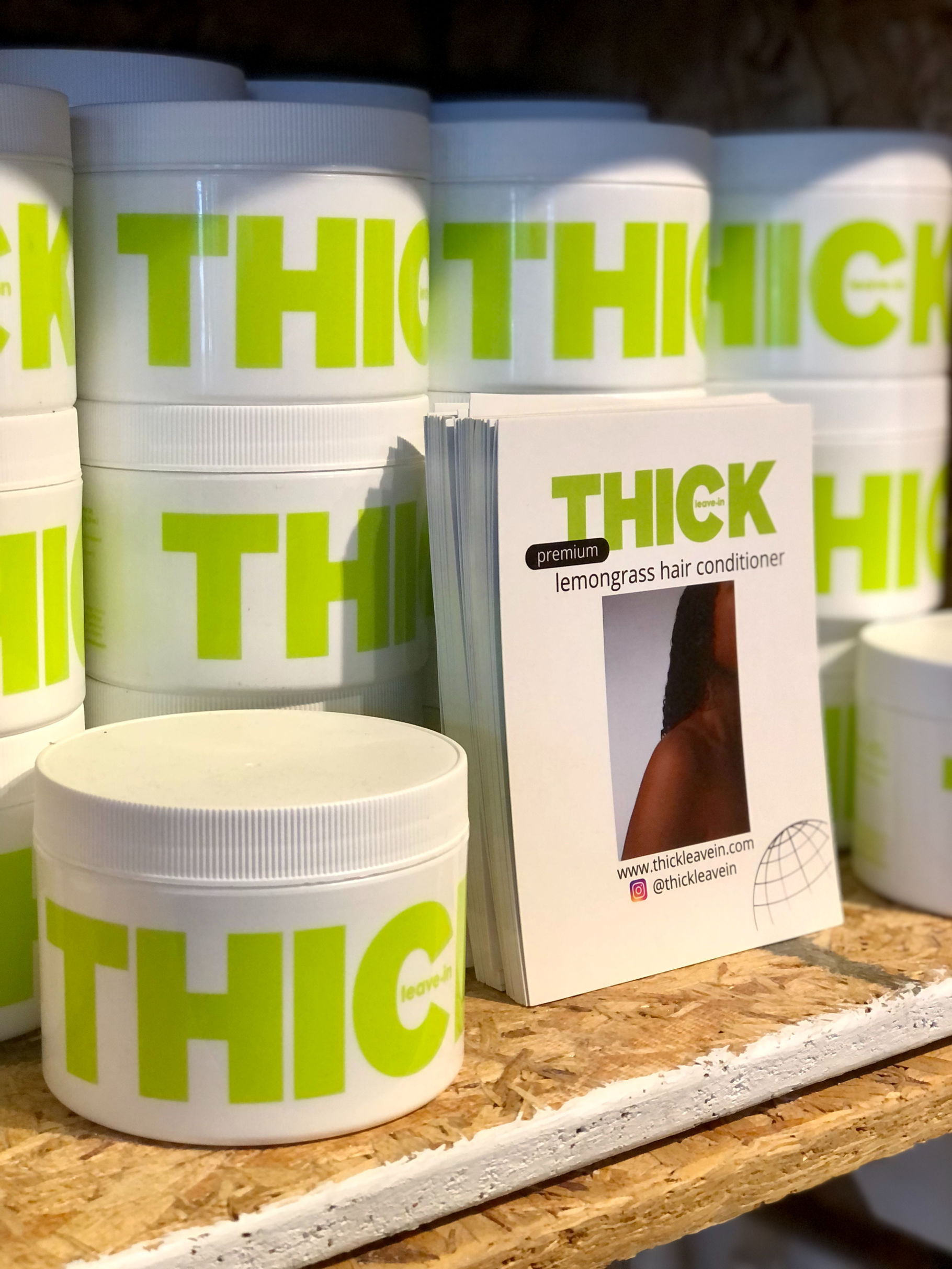 Bottles of Thick Leave-In Lemongrass Hair Conditioner on the shelf at Evergreen Garden Market