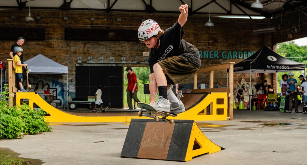 Young person does a skateboard jump off a ramp
