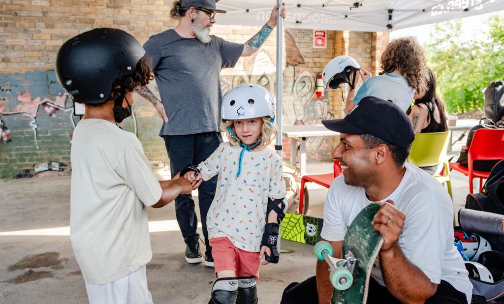 group of kids and adults getting ready to skateboard
