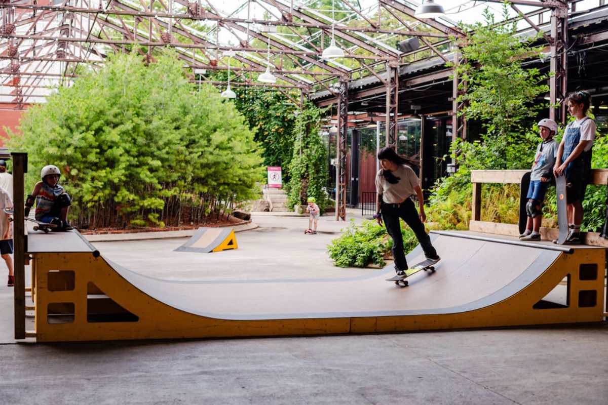 Teens skateboarding on ramp.