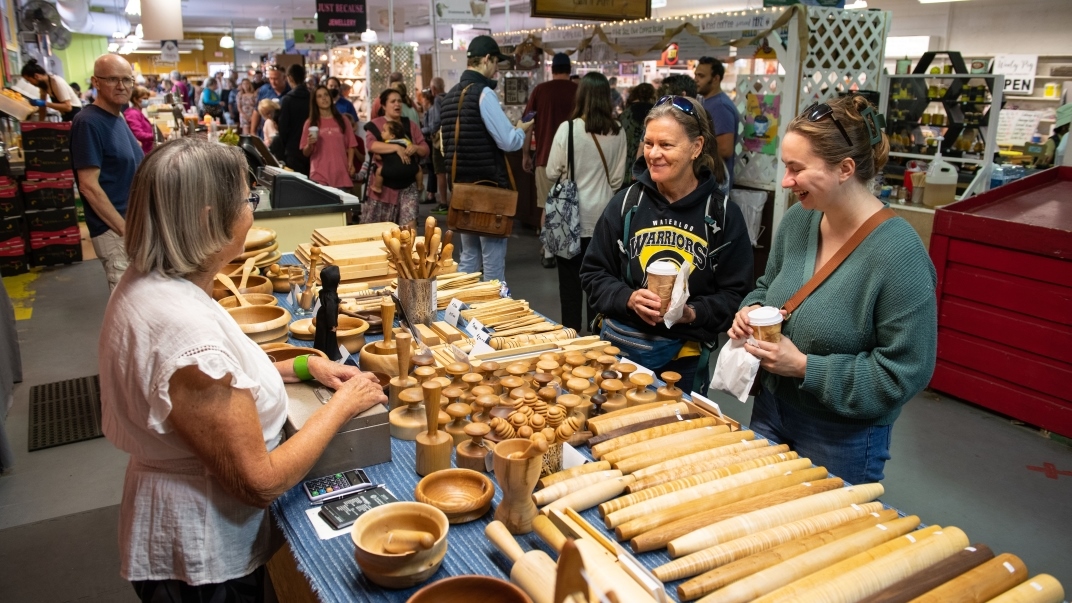 Indoor farmers market people speaking to vendor