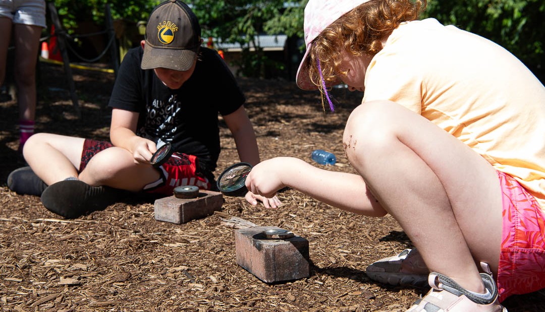 Two young people play outdoors