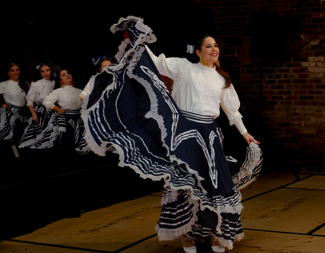 A woman dancing on stage at the Good Mourning Festival at Evergreen Brick Works.