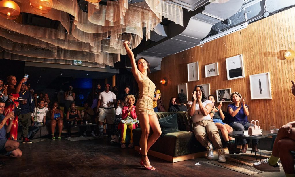 Ballroom performance featuring one performer and spectators