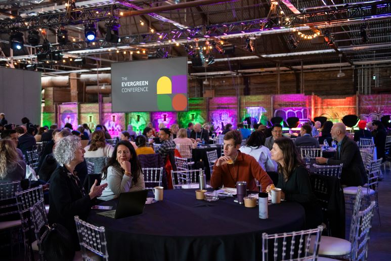 person sitting around tables at the Evergreen conference