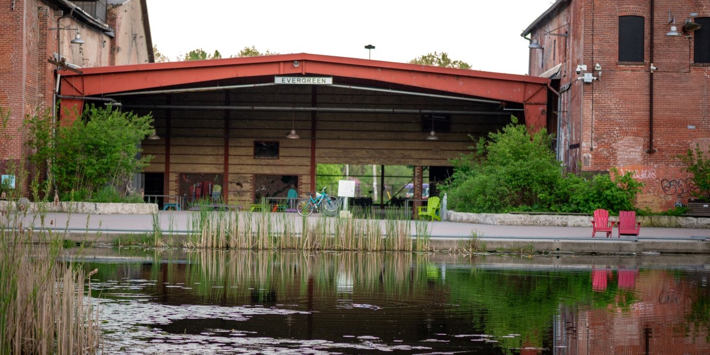 pond with old brick factory building in the background