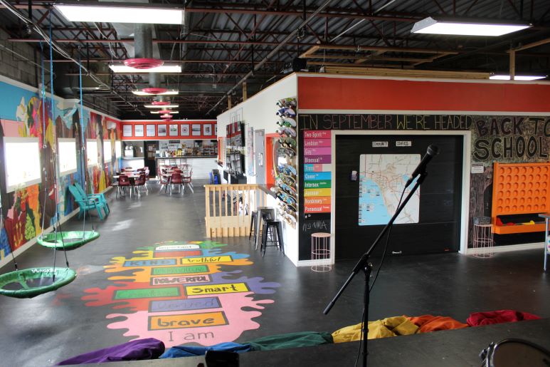 room inside OUTLoud North Bay, with colourful murals, swing chaires and bean bags