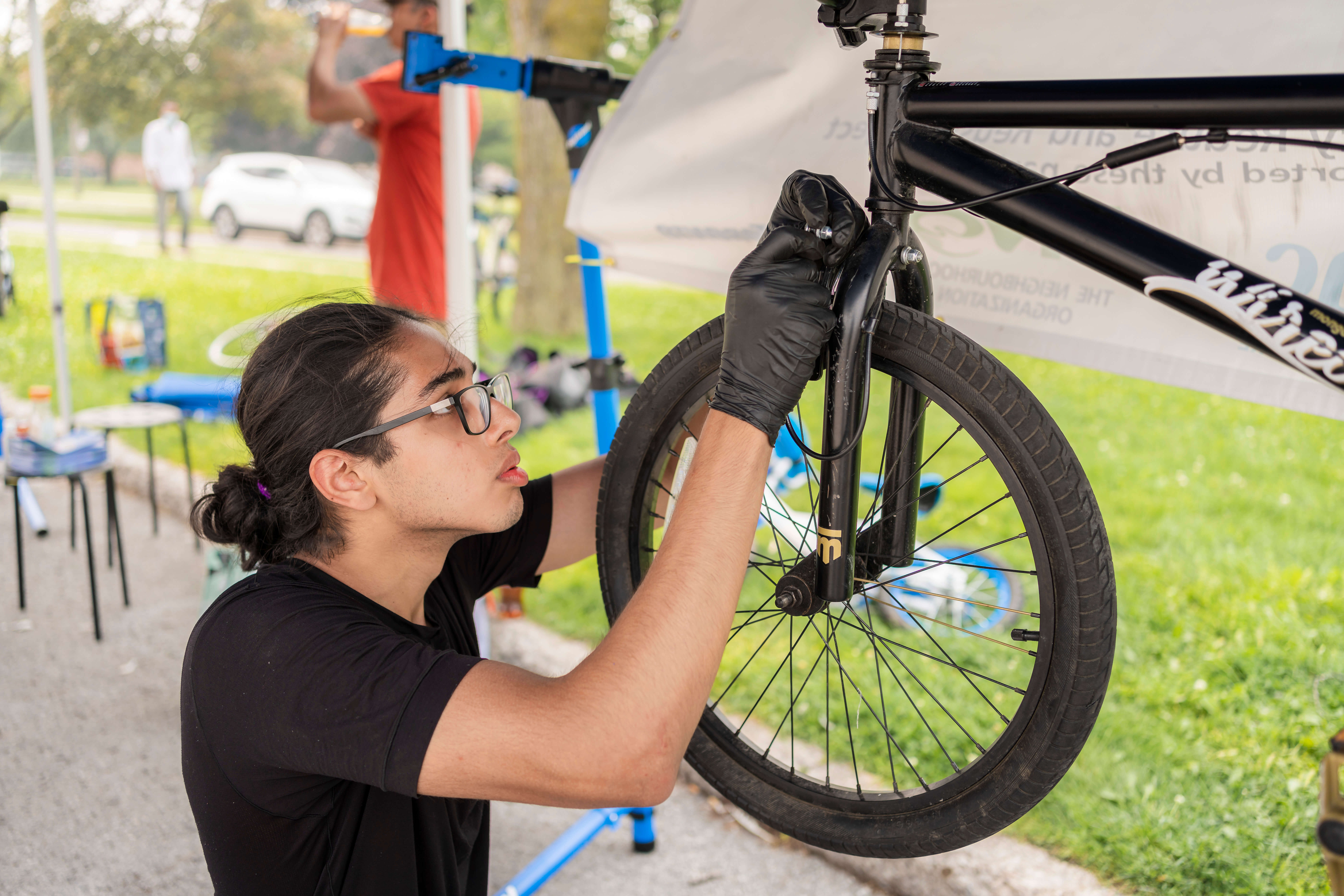 Abdullah fixes a bike at a repair workshop