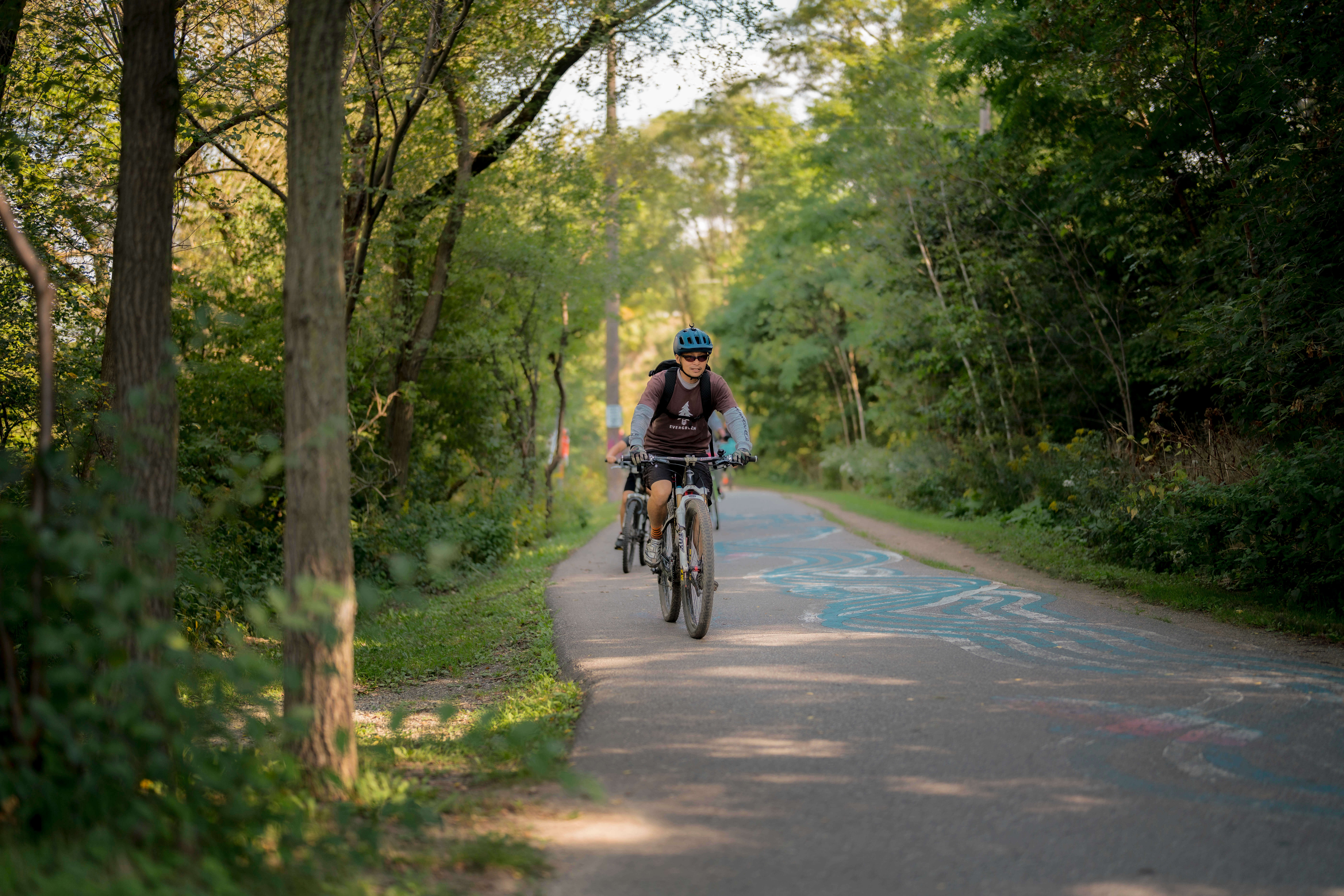 people riding bikes outside on trail