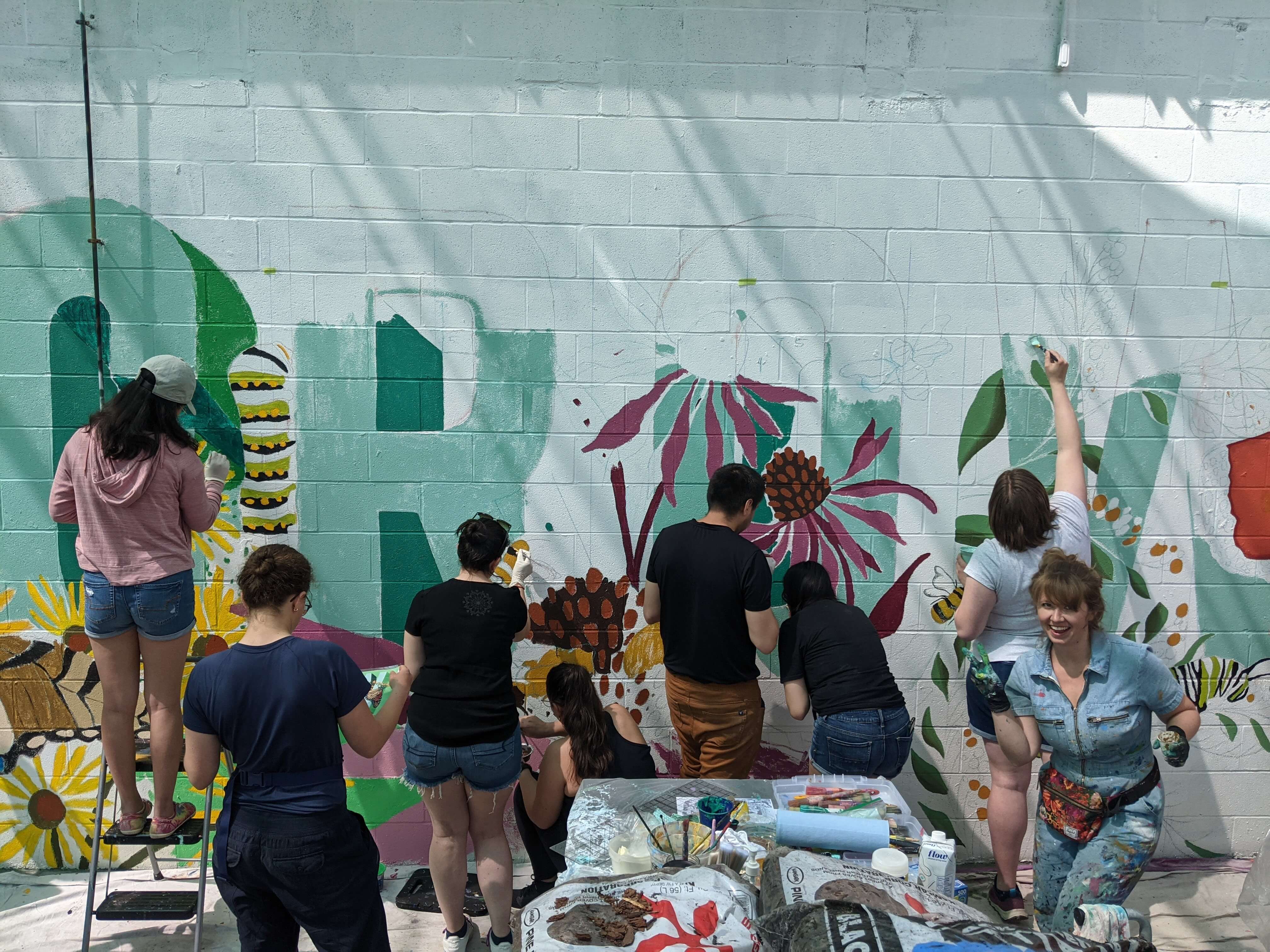 People painting community mural 