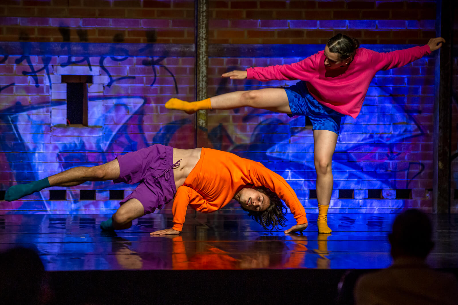 Two peformers dance on stage at Brick Works