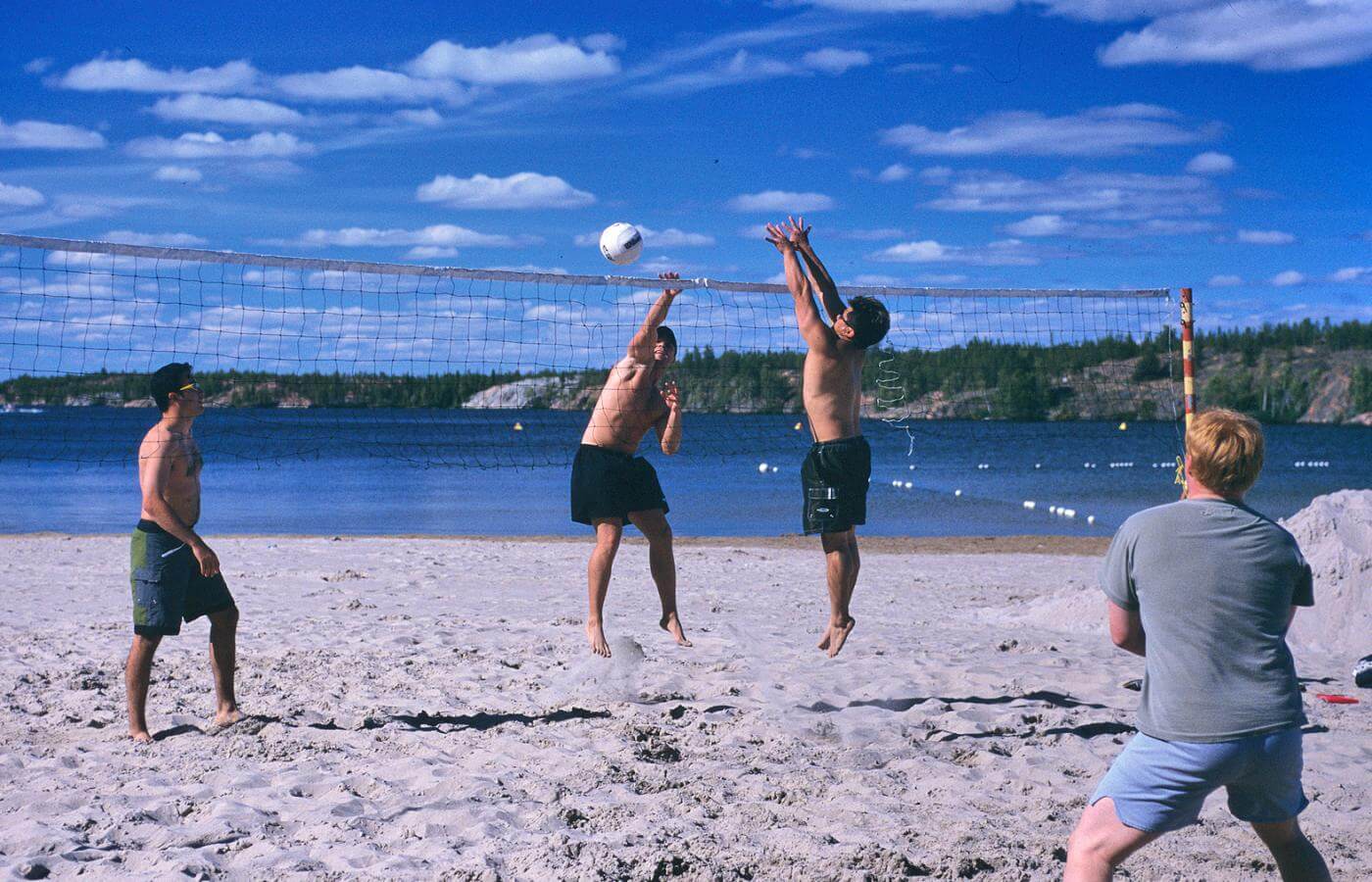 Group playing beach volleyball on the beach