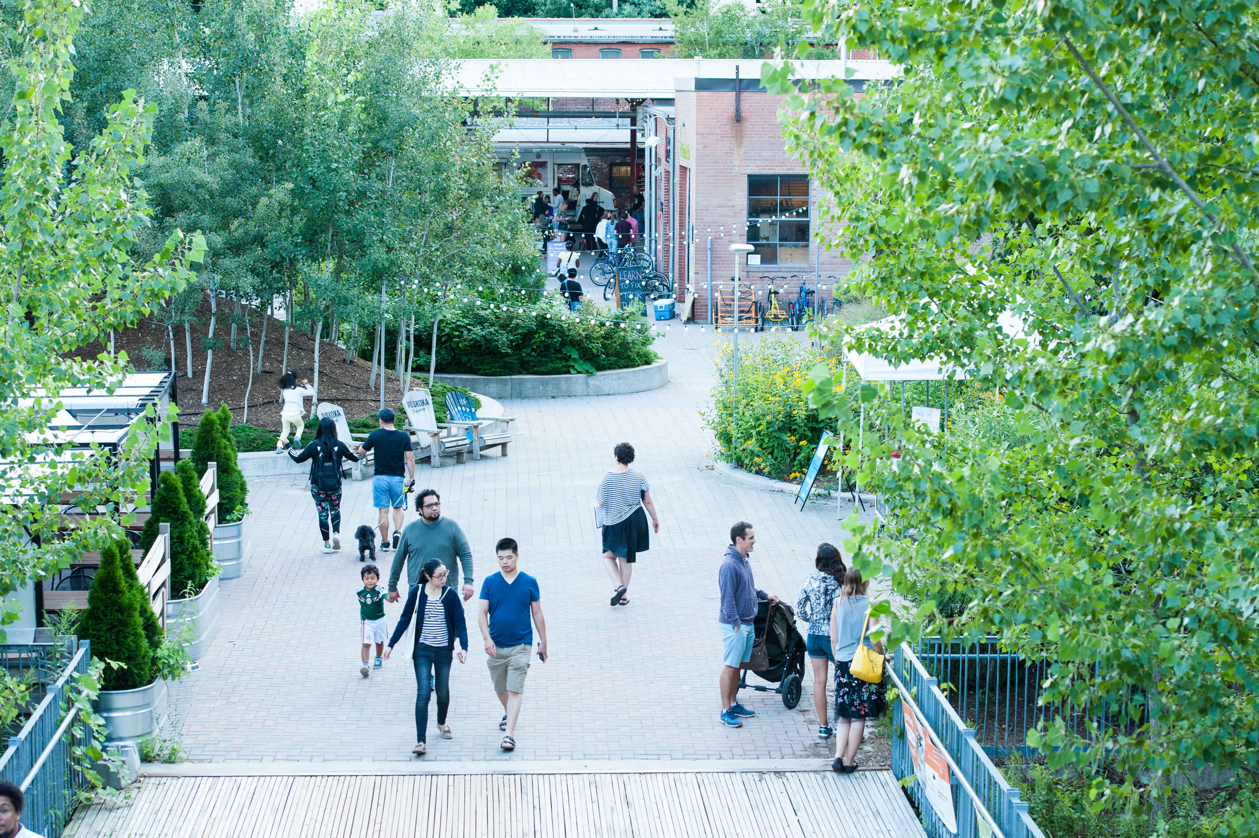 Groups of people walking at Evergreen Brick Works green space