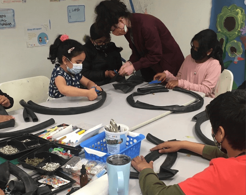 Kids in workshop working on making crafts with bike tubes