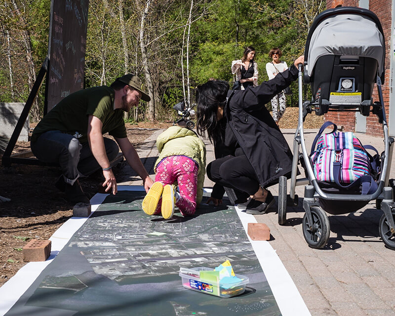 A child draws on chalkboard at Evergreen Brick Works' Ravine Days celebration.