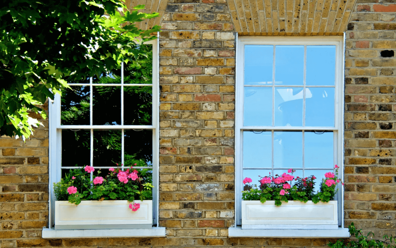 Two windows, with one of the windows having a reflective coating