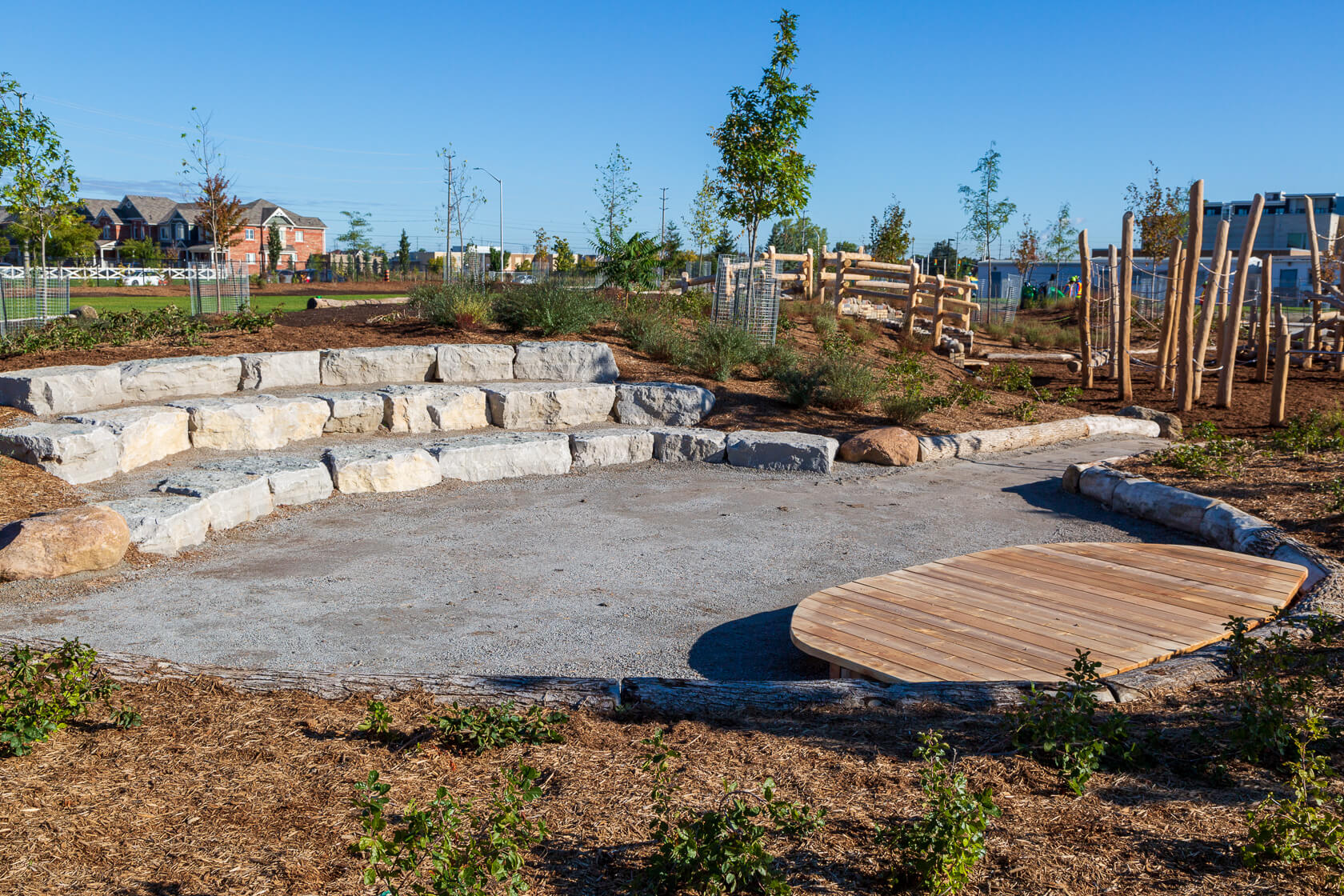 Wood platform and stone seating areat at Irma Coulson Public School