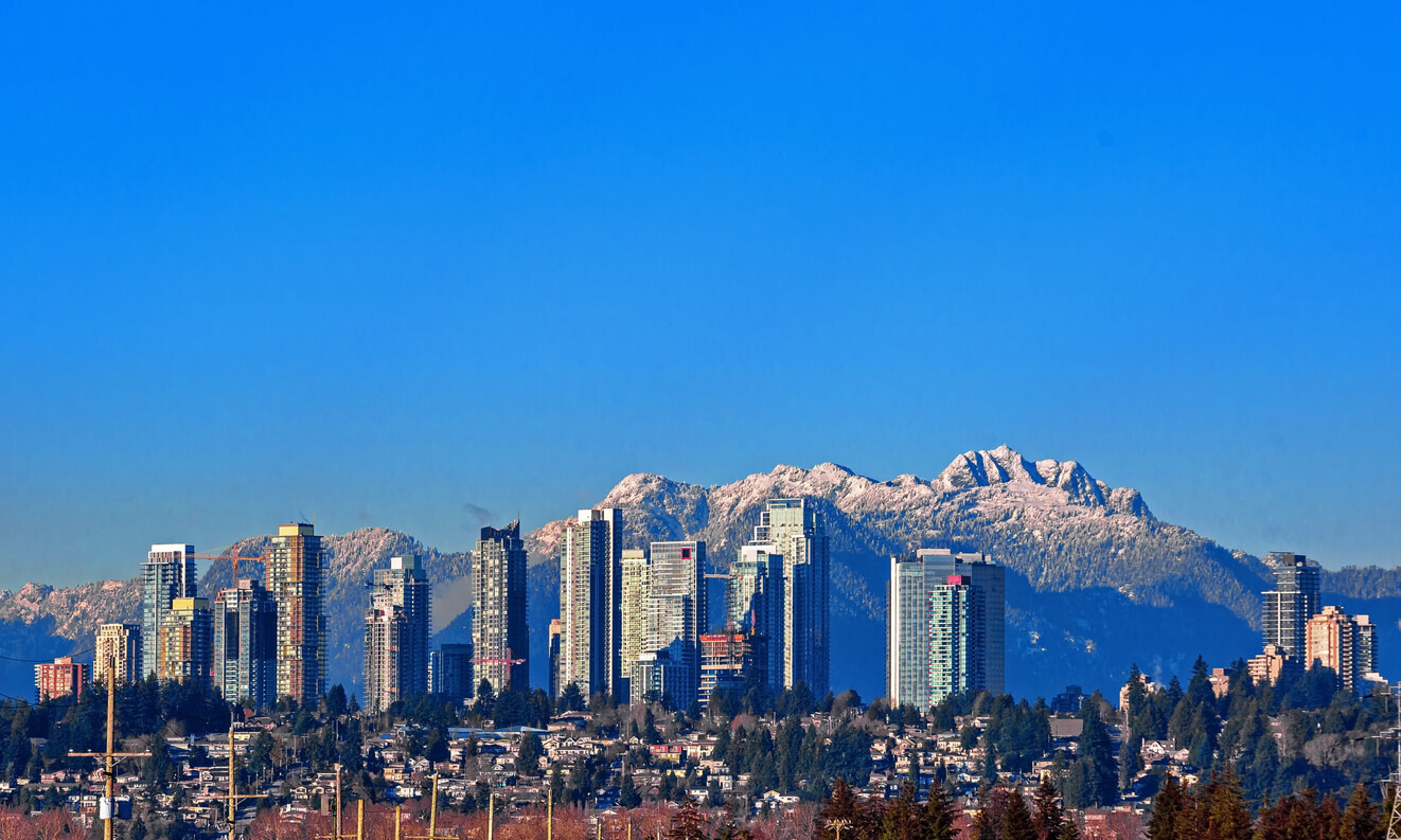 Burnaby skyline with buildings in front on mountains