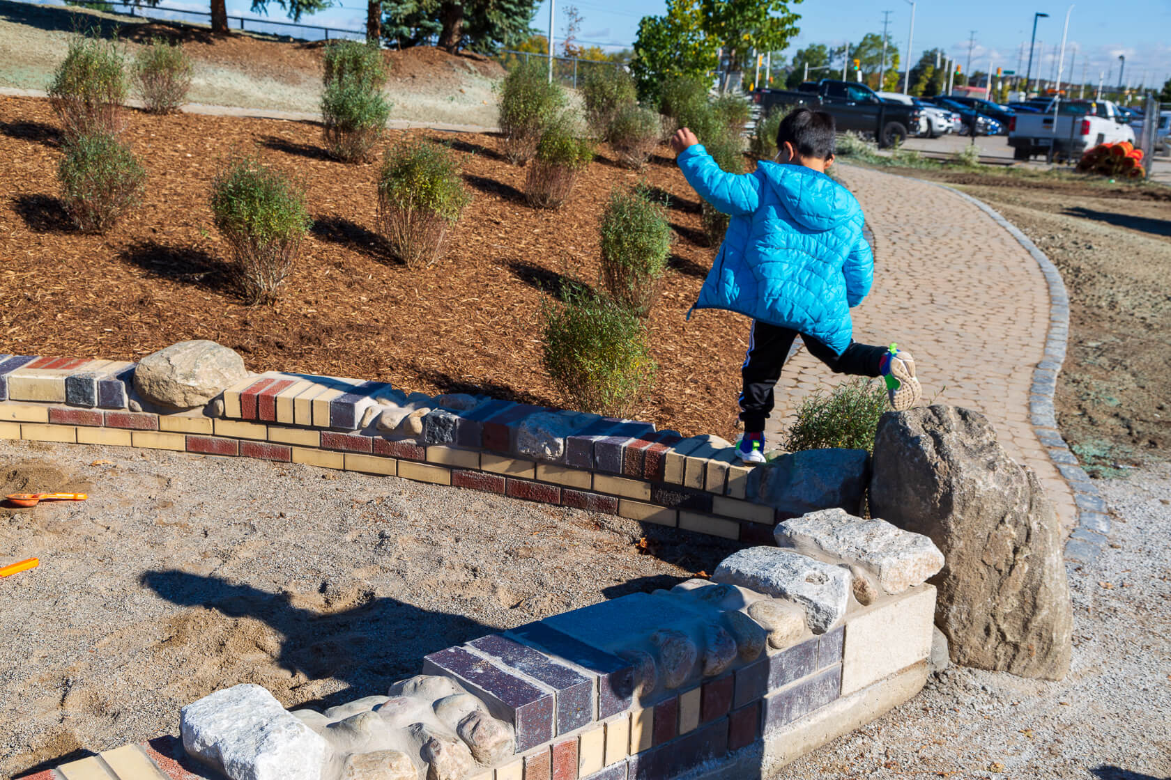 Edge walls between sand and pathways in playground