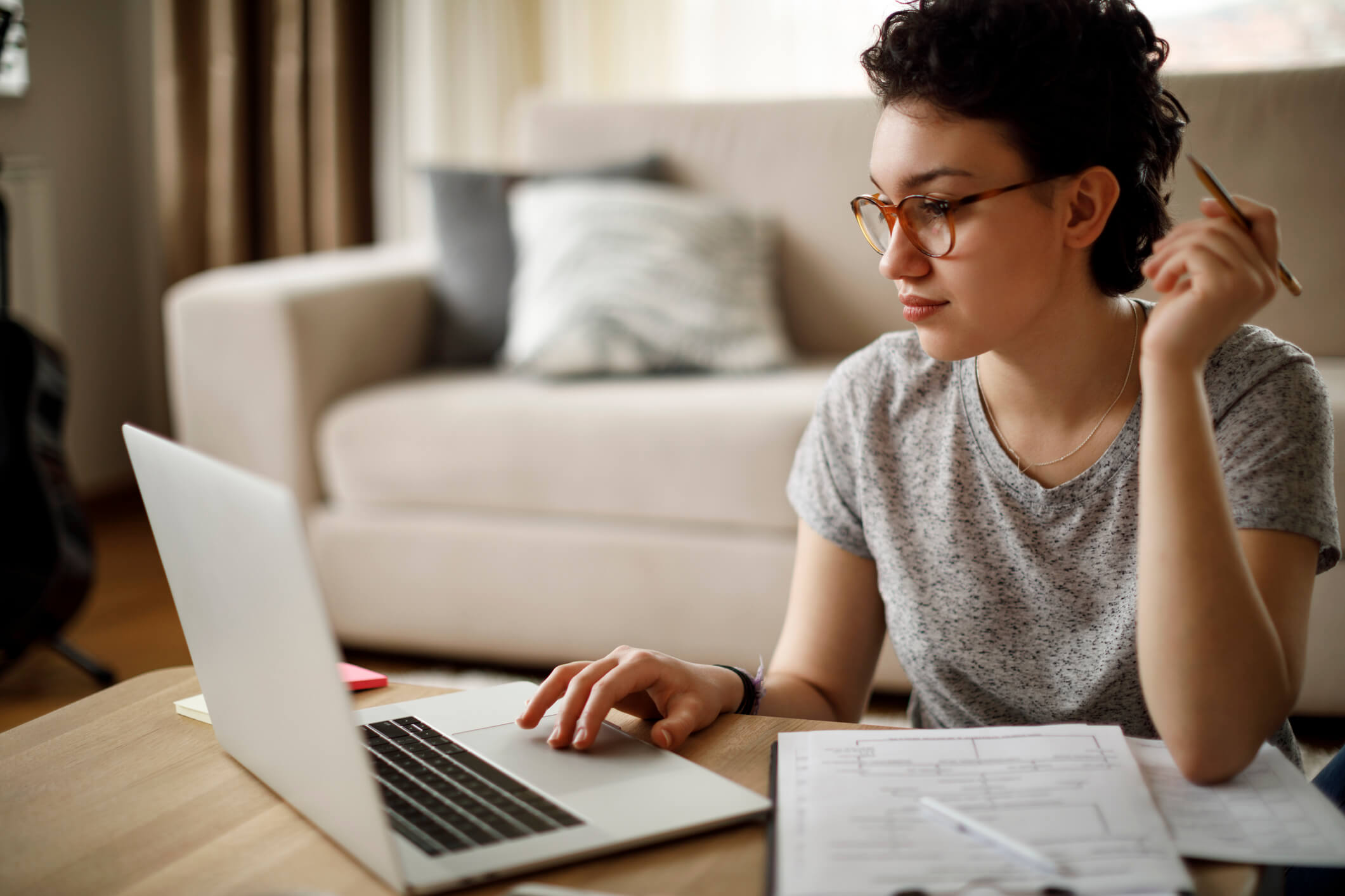 women sits at desk on her computer