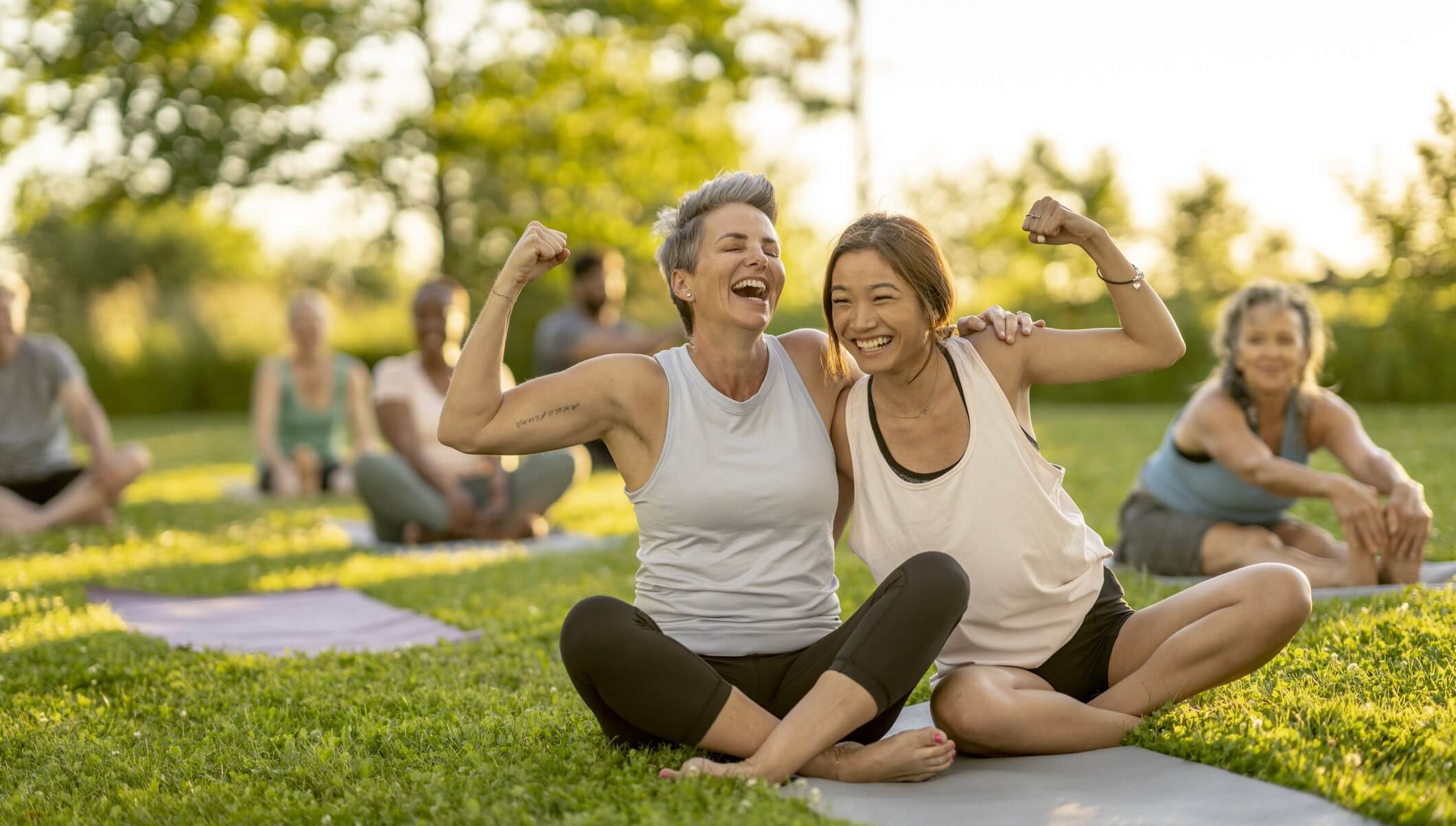 group on yoga matts outdoors in park
