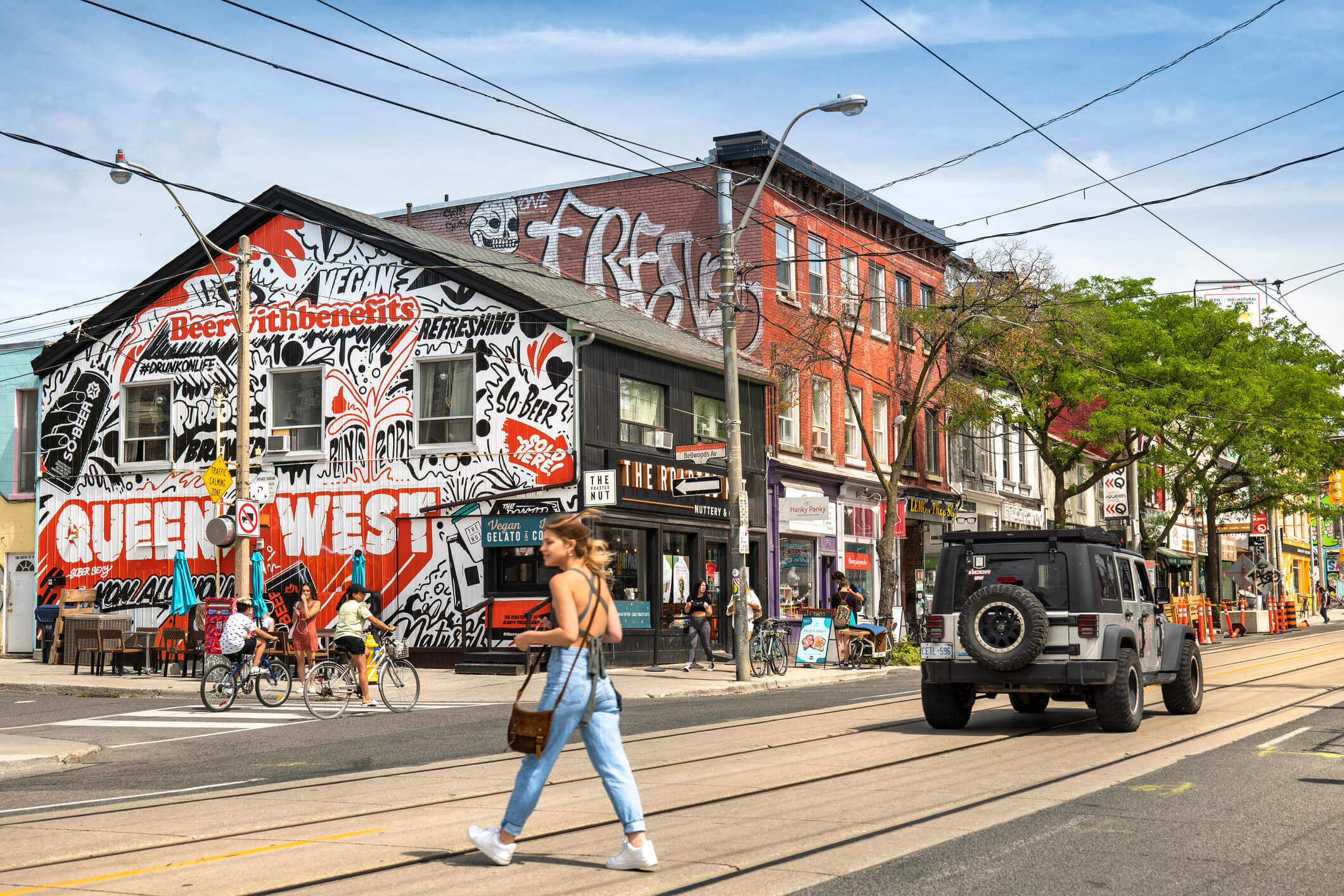 Urban street scene with cars, pedestrians and businesses