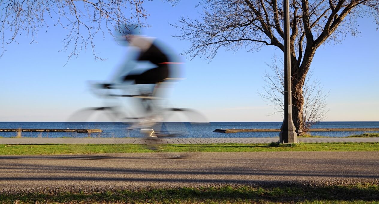 Person shown biking along waterfront trail in Toronto