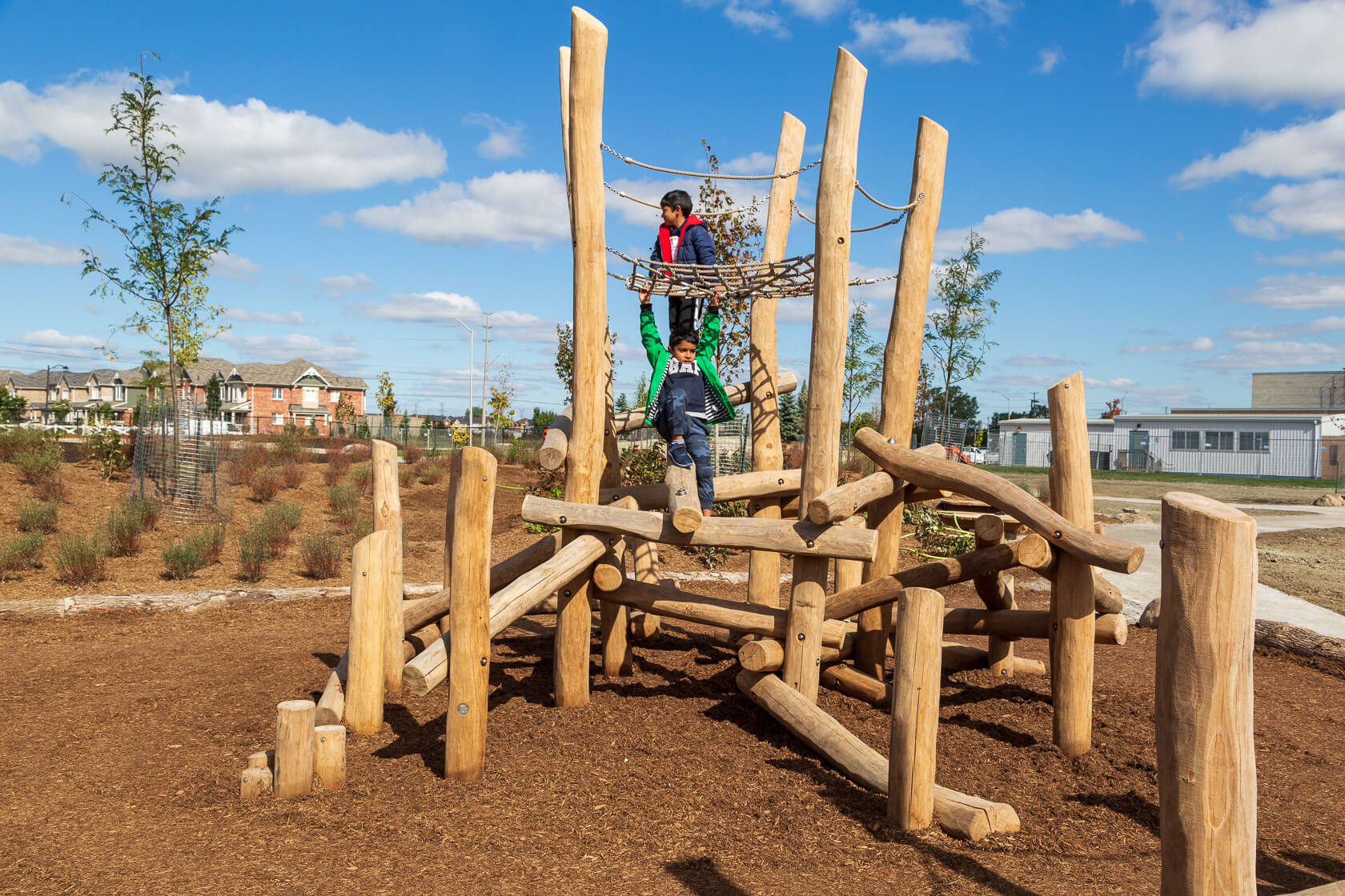 Kids playing outside on a climbing structure