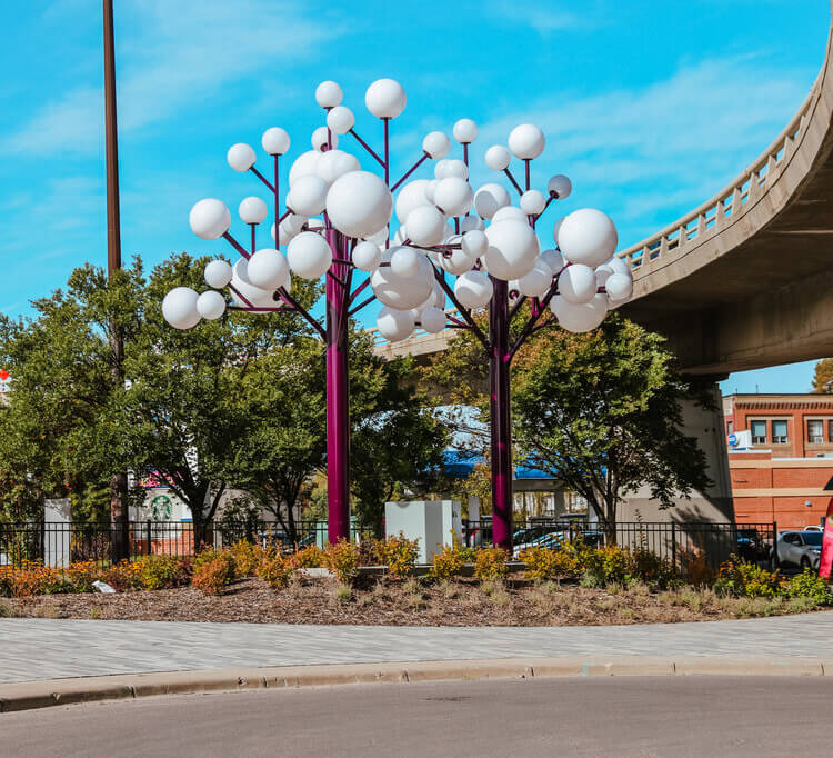 Park space with garden and trees under overpass