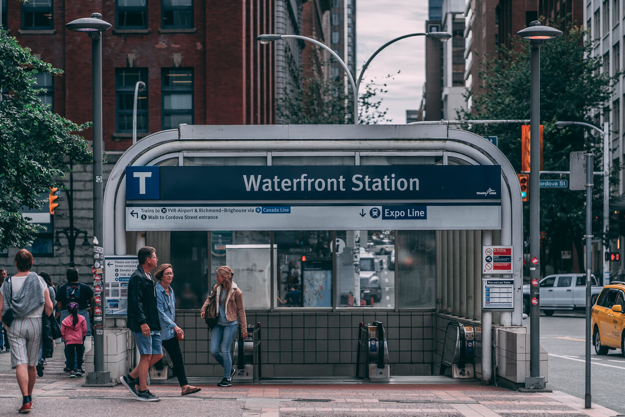 People walk into train station in vancouver neighbourhood